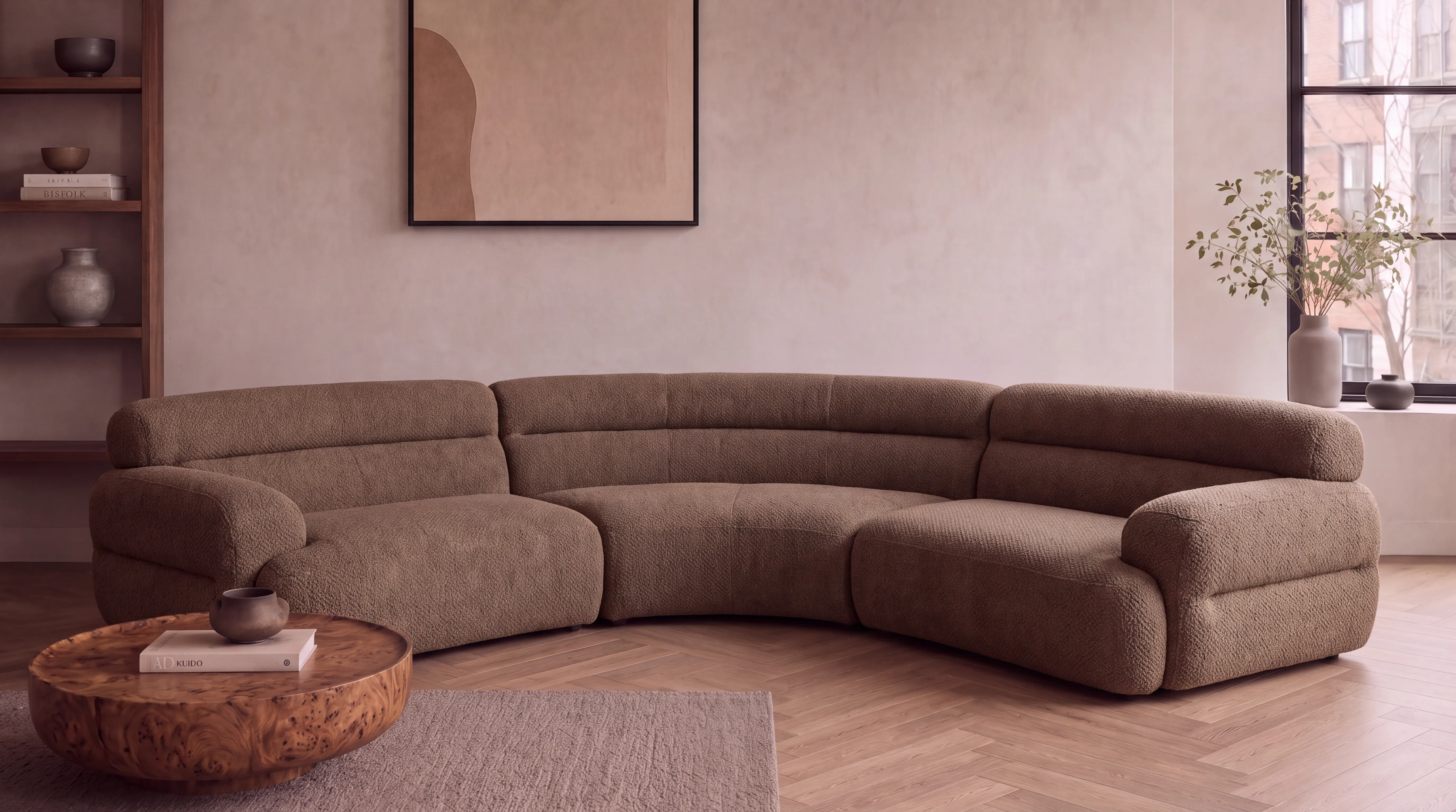 Mocha boucle curved modular sofa in a bright room